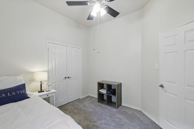 Bedroom featuring carpet floors, a ceiling fan, baseboards, and a closet | Image 30