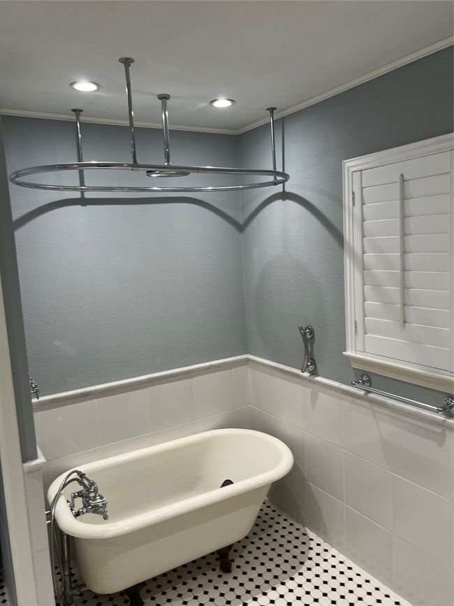 Bathroom featuring a freestanding bath, wainscoting, tile walls, recessed lighting, and tile patterned flooring | Image 22