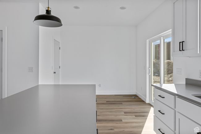 Unfurnished dining area featuring baseboards and light wood-type flooring | Image 8