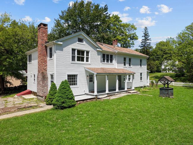 This side of the house features a covered porch. | Image 4