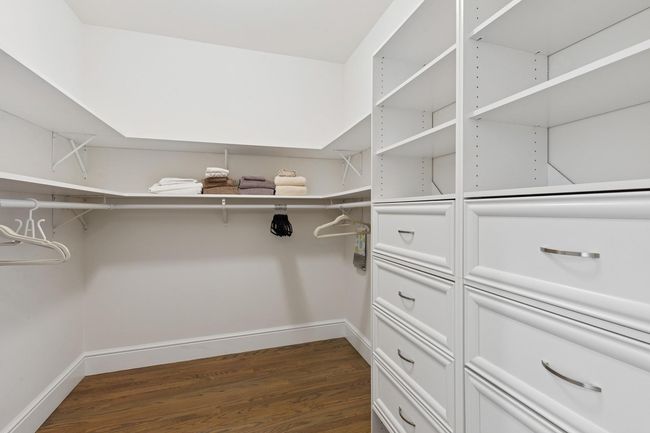 Walk in closet with dark wood-style flooring | Image 13