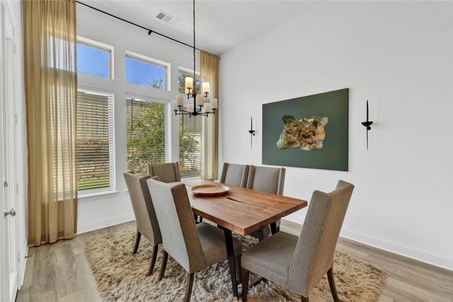 Dining area with a chandelier, light wood-style flooring, and baseboards | Image 16