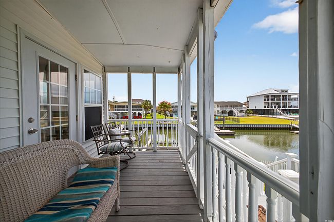 Sunroom / solarium featuring a water view and a residential view | Image 6