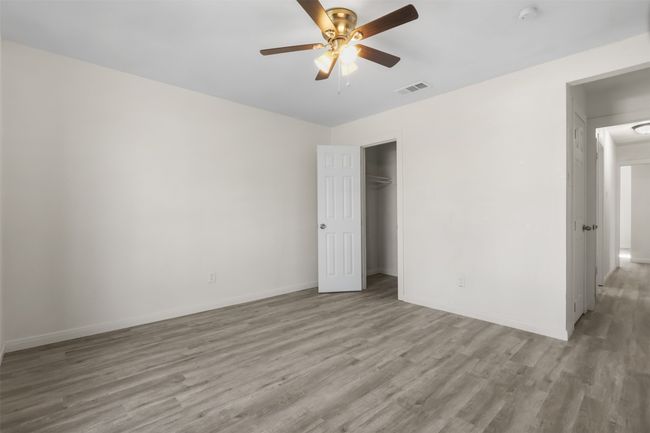 Unfurnished bedroom featuring ceiling fan, light hardwood / wood-style flooring, and a closet | Image 10