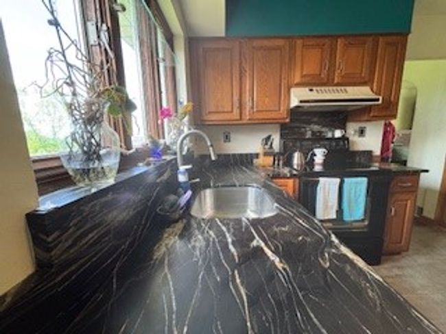Marbled granite counter tops and back splash. | Image 10