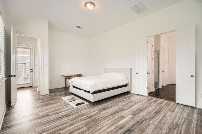 Bedroom featuring wood finished floors and baseboards | Image 15