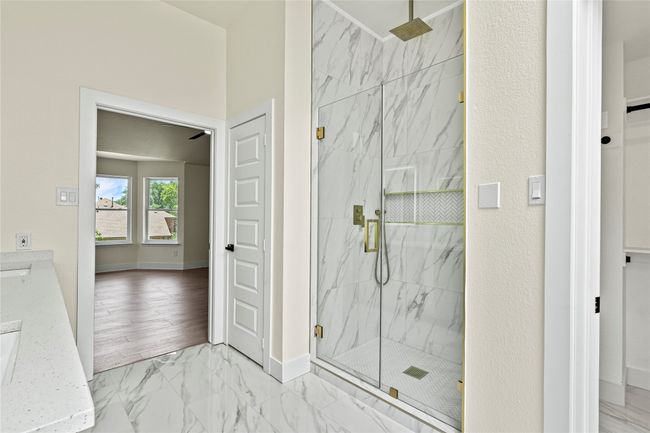 Bathroom featuring a marble finish shower and marble finish floors | Image 22