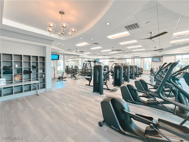 Gym featuring carpet floors, plenty of natural light, and a chandelier | Image 43