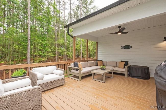 Wooden terrace featuring an outdoor living space and ceiling fan | Image 46