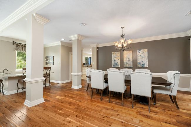 Imagine the ease of entertaining here—conversations flowing from the dining table to the bar and beyond, with plenty of room to gather, toast, and celebrate life’s everyday wins. | Image 16