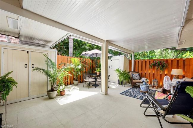Fenced backyard with a shed, a patio area, and outdoor dining space | Image 5