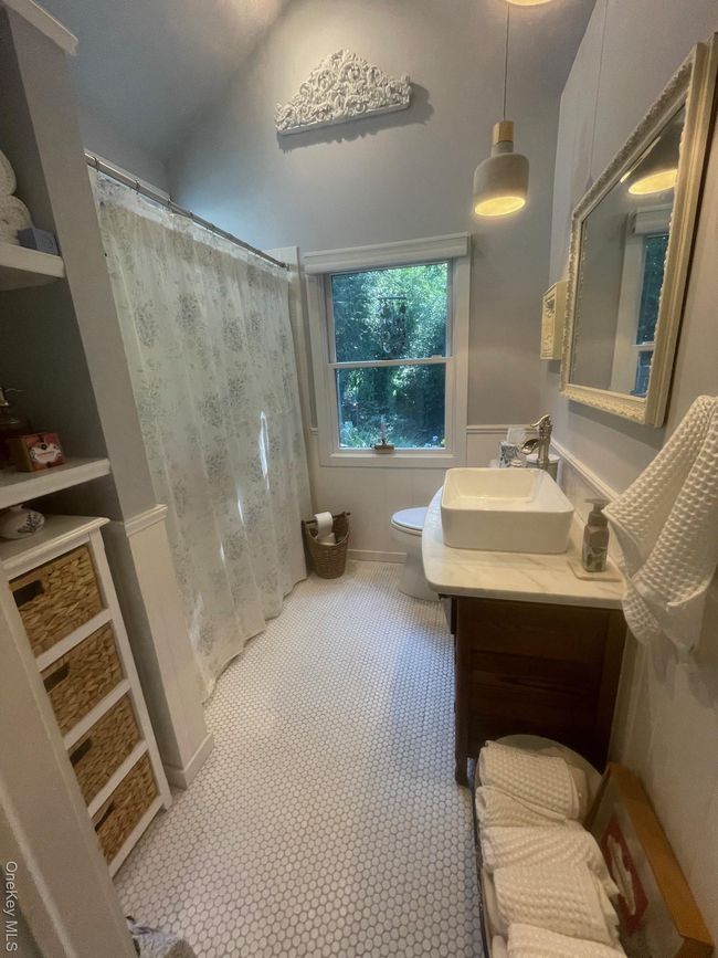 Bathroom featuring toilet and vanity | Image 11