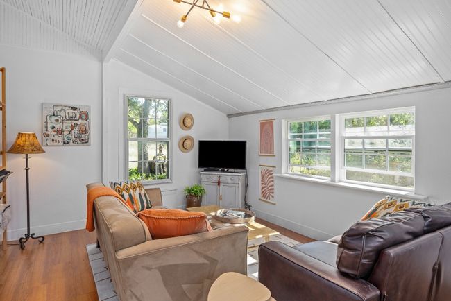 Living area featuring lofted ceiling, healthy amount of natural light, and wood finished floors | Image 24