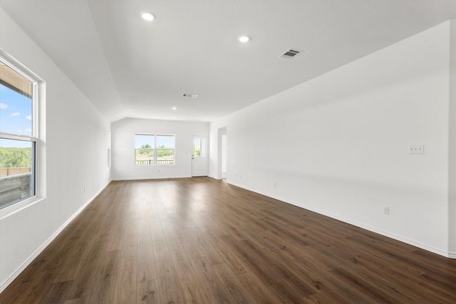 Unfurnished room featuring dark wood-style floors, recessed lighting, and vaulted ceiling | Image 10