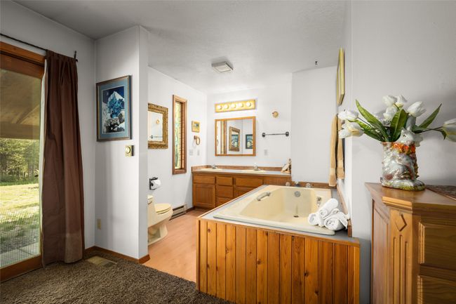 Full bathroom featuring toilet, a jetted tub, vanity | Image 15
