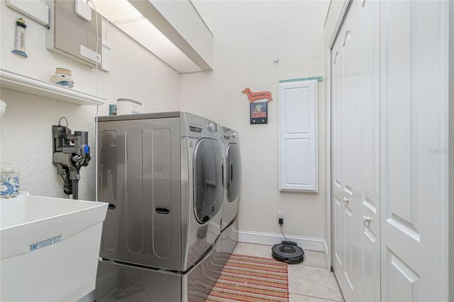 Laundry room with raised washer & dryer and skylight | Image 50