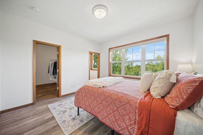 Upstairs are three bedrooms, including a spacious primary suite and laundry. | Image 29