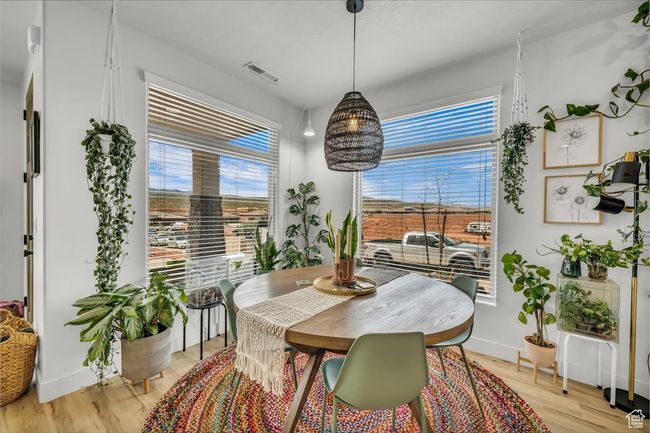 Dining room with a wealth of natural light, visible vents, and light wood finished floors | Image 9