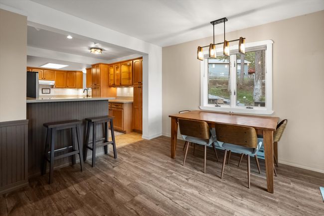 Dining space featuring wood finished floors and baseboards | Image 15