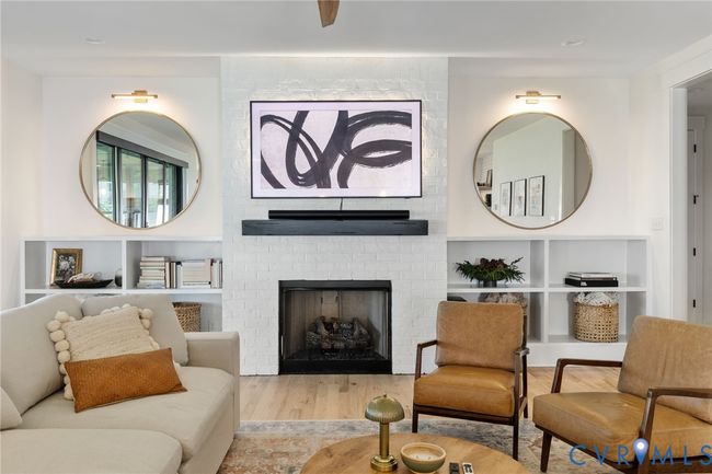 Living area featuring wood finished floors and a brick fireplace | Image 20