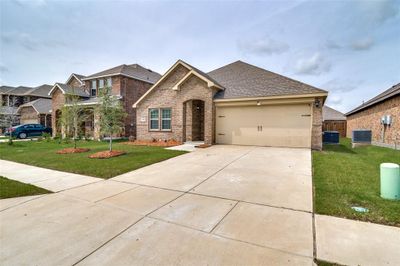 View of front facade with a garage, central AC, and a front lawn | Image 2