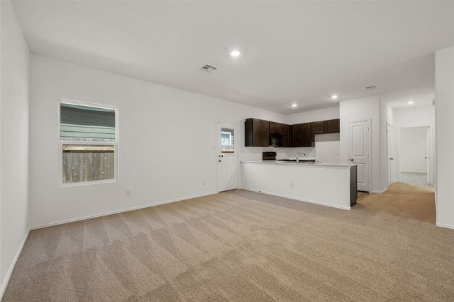 Unfurnished living room featuring light carpet and recessed lighting | Image 12