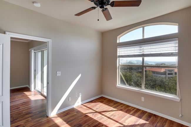 Spare room with a smoke detector, ceiling fan, and dark wood finished floors | Image 16