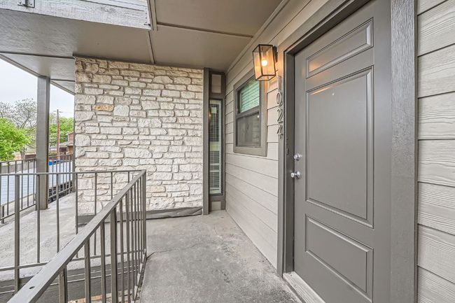Property entrance featuring covered porch and stone siding | Image 4