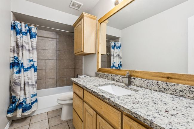 Bathroom featuring vanity, tile patterned floors, and shower / tub combo with curtain | Image 20