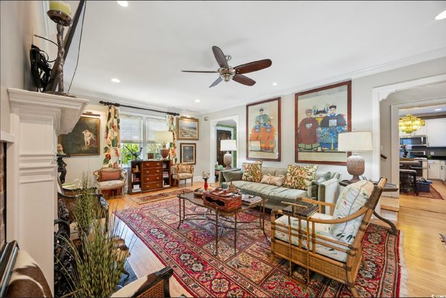 Living room featuring ornamental molding, a ceiling fan, light wood-type flooring, recessed lighting, and a chandelier | Image 31