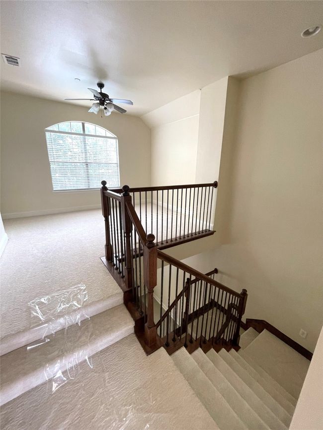 Stairs with carpet and ceiling fan | Image 11