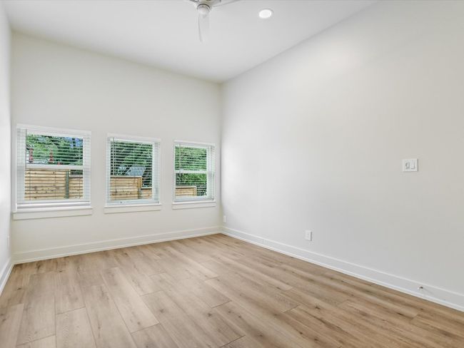 Spare room featuring light wood-style floors, baseboards, a ceiling fan, and recessed lighting | Image 16