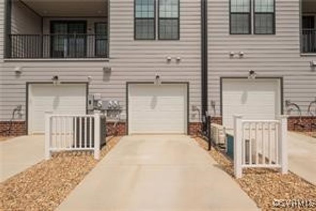 Rear view of house with concrete driveway and a garage | Image 50