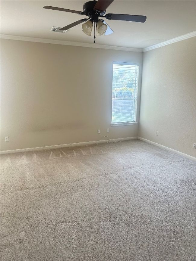 Carpeted spare room featuring crown molding and a ceiling fan | Image 14