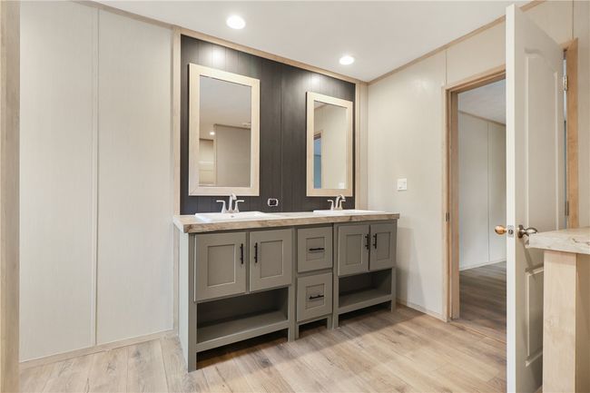 Bathroom featuring double vanity, a sink, and wood finished floors | Image 26