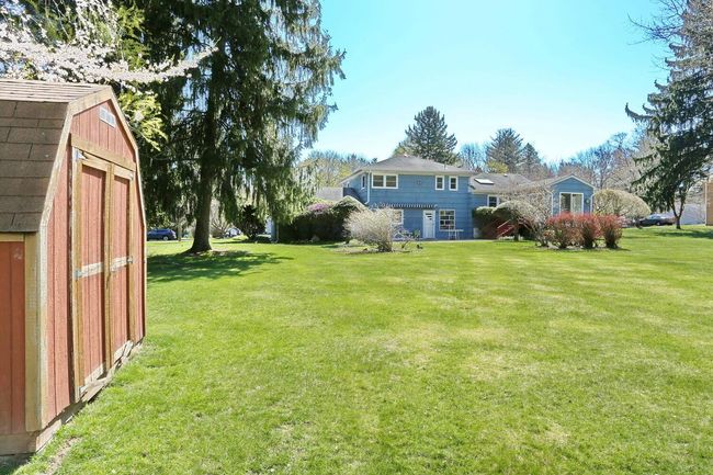 View of yard with a storage unit and an outbuilding | Image 35
