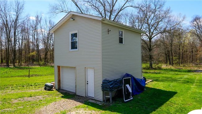 View of outbuilding with a garage and dirt driveway | Image 29