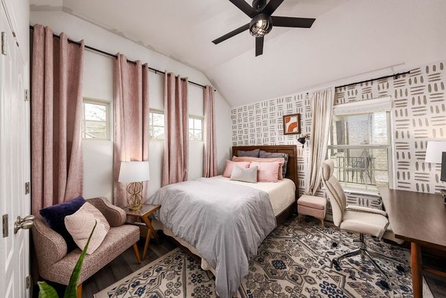 Bedroom featuring wallpaper, a ceiling fan, vaulted ceiling, and wood type floors | Image 14