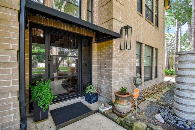 Entry features wide steel door with glass panes. Notice the beautiful black fabric awning to keep the rain and light off of guests. Features you rarely find in homes of this price point. | Image 6
