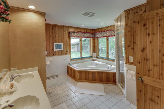 Main floor full bath with a walk-through to the primary bedroom. | Image 24