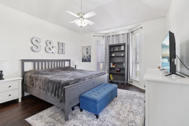 Bedroom with dark wood-type flooring and a ceiling fan | Image 17