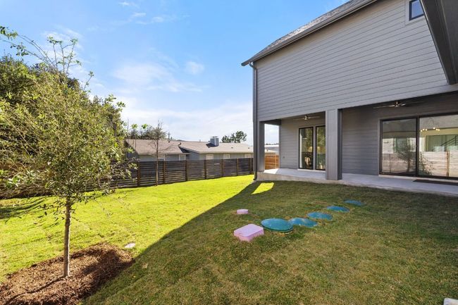 View of yard featuring a ceiling fan, fence, and a patio | Image 31