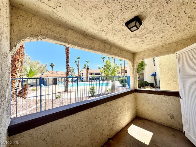 Patio with view of pool | Image 9