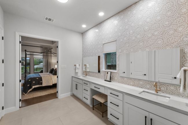 Spa-inspired retreat with dual vanities, tiled walls and large walk-in shower | Image 22