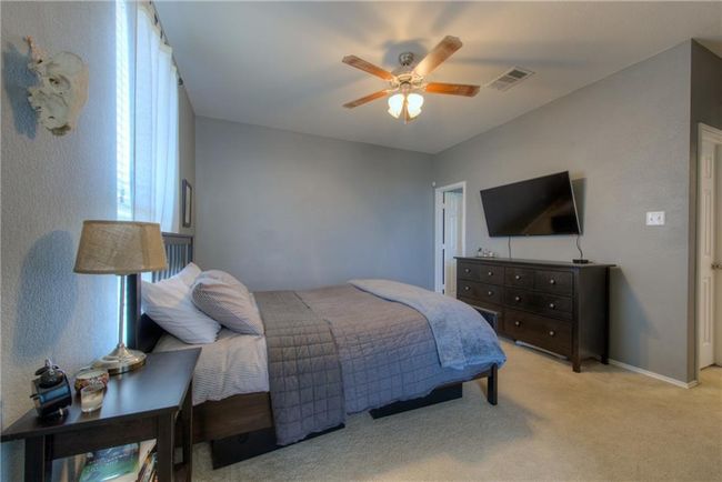 Bedroom with light colored carpet and a ceiling fan | Image 7