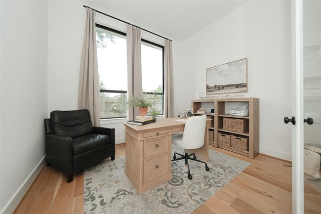 Bright and inviting study with expansive windows. | Image 17