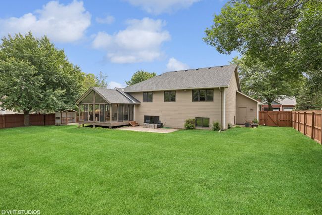 Enjoy this backyard concrete patio, perfect for grilling and relaxing with friends | Image 38