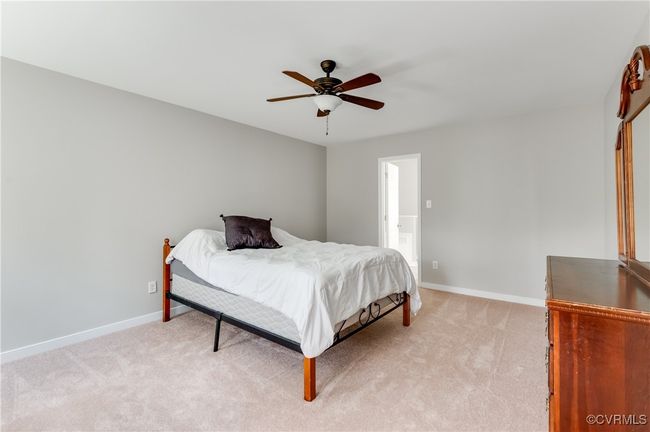 Primary Bedroom featuring light carpet, baseboards, and ceiling fan | Image 15