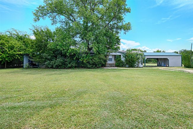 View of grassy yard with a carport | Image 27