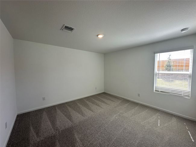 Carpeted empty room featuring a textured ceiling and recessed lighting | Image 10